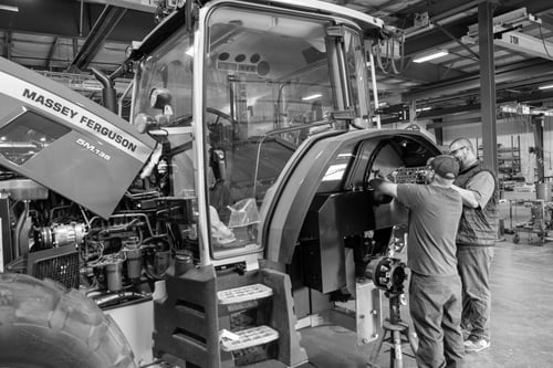 2 guys working on a Massey