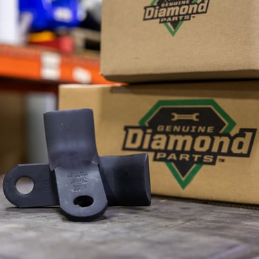 flail knives on a table with shipping boxes behind
