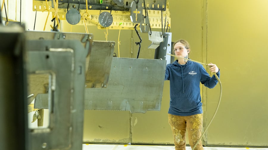 person cleaning metal before applying paint