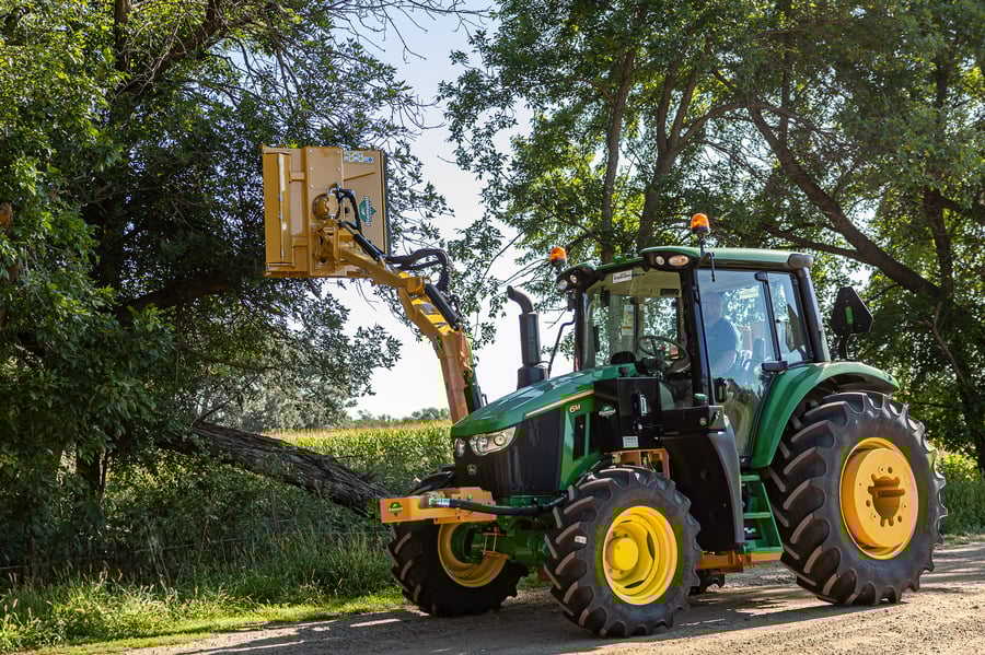 tractor mid-mount boom mower cutting trees